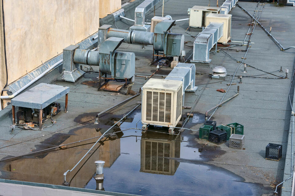 commercial roof leak repair-close up of standing water on a commercial rooftop